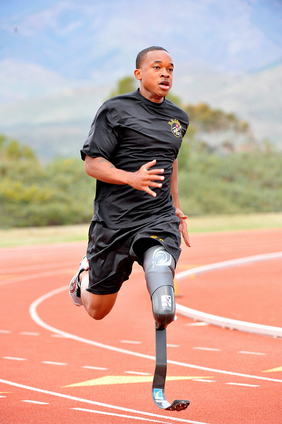 Prosthesis user running on a track